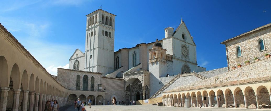 Scenic view of the Basilica of Saint Francis in Assisi with clear blue skies.